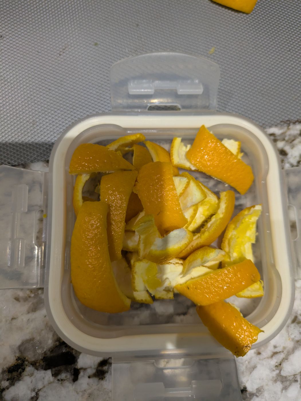 Fresh orange peels in a mixer